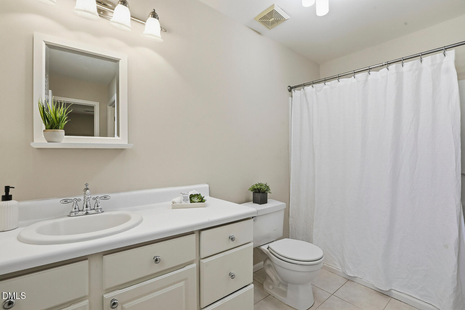 1220 Stoneferry Lane Raleigh, NC 27606 - Photo 18 of 40 a bathroom with a toilet sink and mirror