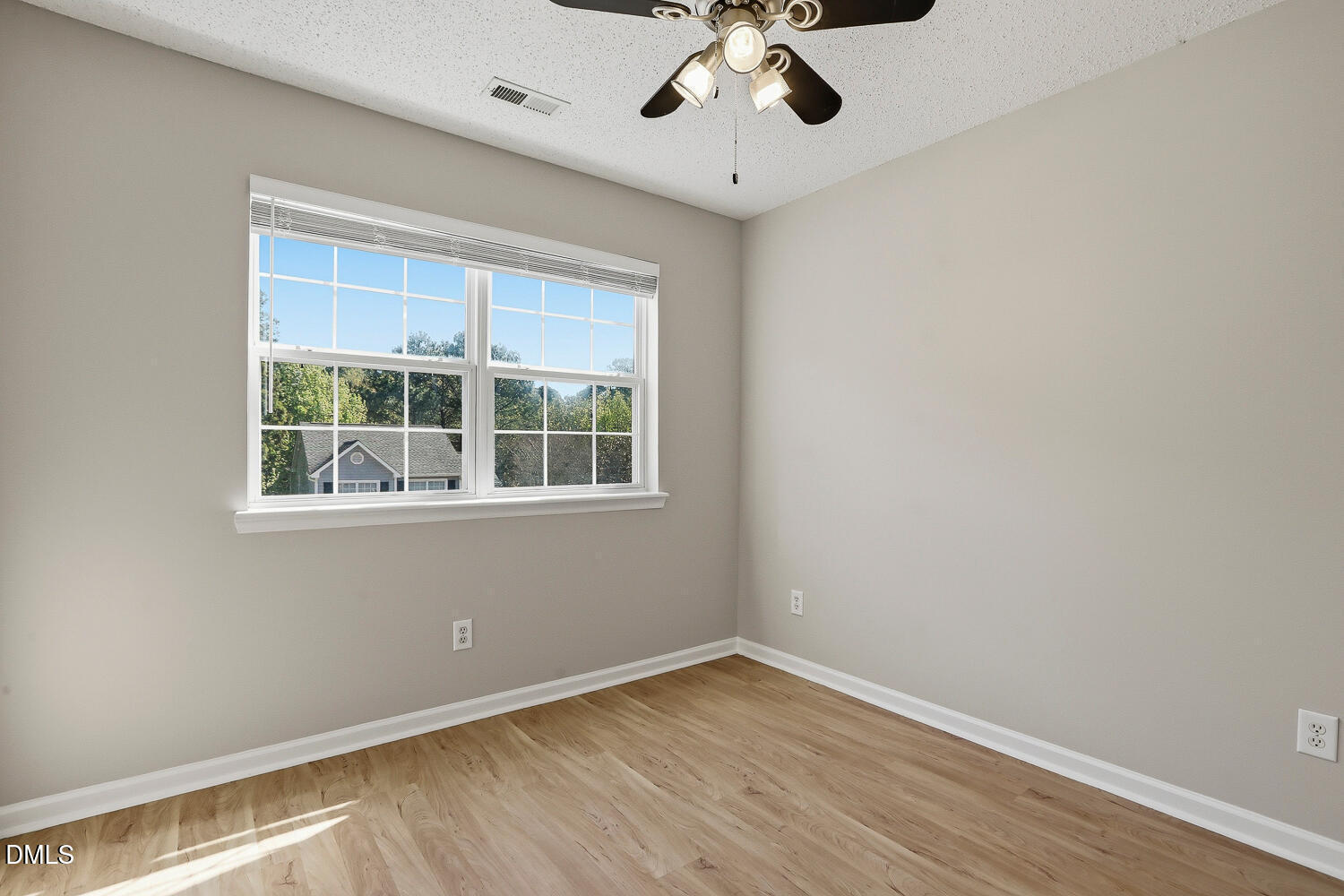 1220 Stoneferry Lane Raleigh, NC 27606 - Photo 20 of 40 a view of an empty room with wooden floor and a window