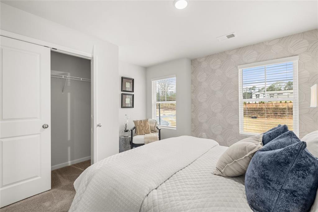 241 Epping Street, Unit 88 Stockbridge, GA 30281 - Photo 51 of 64 a bedroom with a bed and a large window