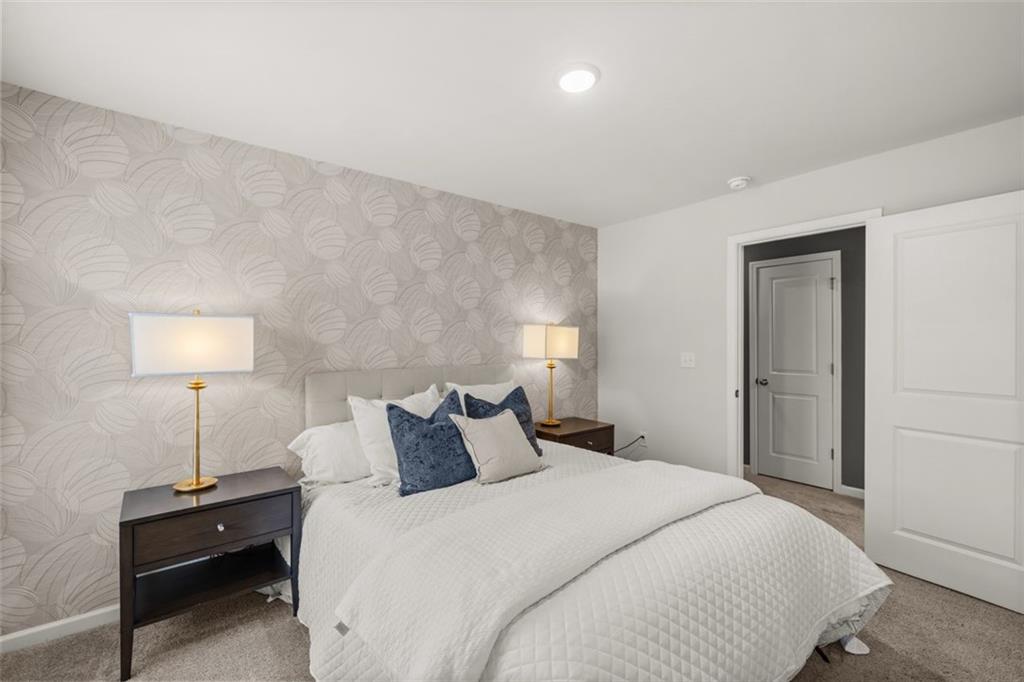 241 Epping Street, Unit 88 Stockbridge, GA 30281 - Photo 52 of 64 a bedroom with a bed and a lamp