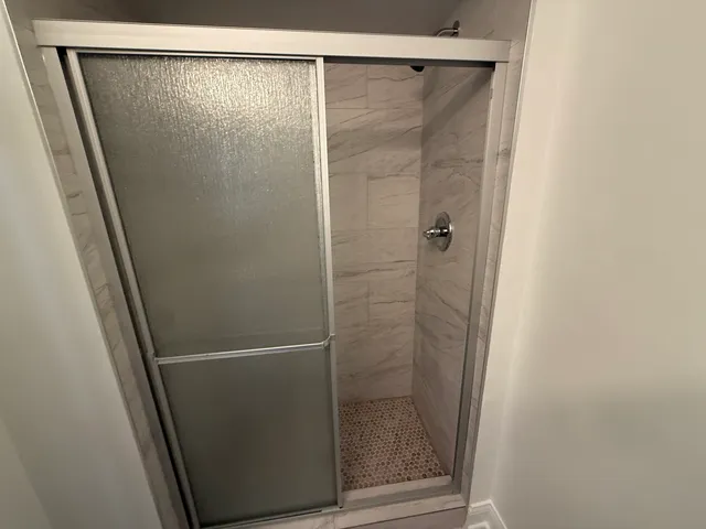 a bathroom with a glass shower door