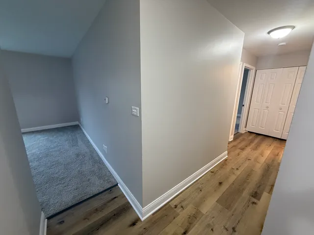 a view of hallway with wooden floor