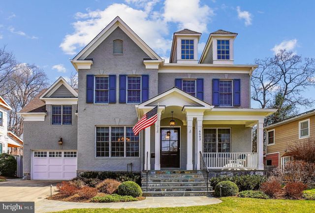 a front view of a house with a yard outdoor seating and garage