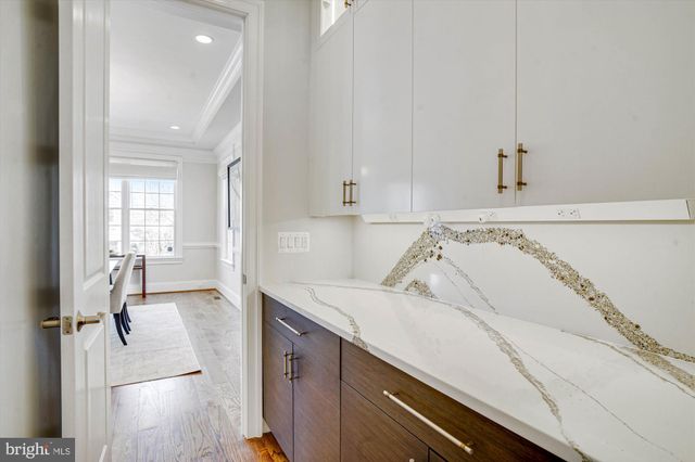 a large kitchen with stainless steel appliances kitchen island granite countertop a sink and cabinets