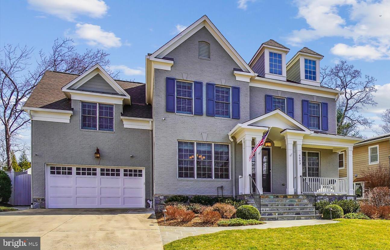 6603 Pyle Road Bethesda, MD 20817 - Photo 2 of 91 a front view of a house with a yard outdoor seating and garage