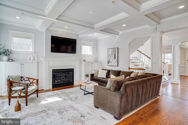 a bathroom with a granite countertop sink a mirror and wooden floor