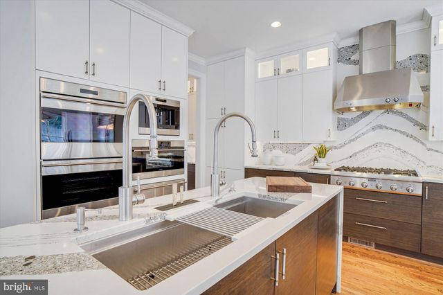 a spacious bedroom with a bed and a flat screen tv