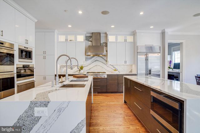 a view of walk in closet with clothes