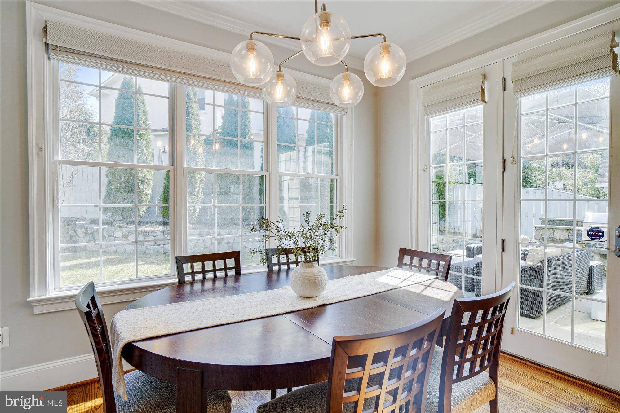 6603 Pyle Road Bethesda, MD 20817 - Photo 33 of 91 a view of a dining room with furniture large windows and wooden floor