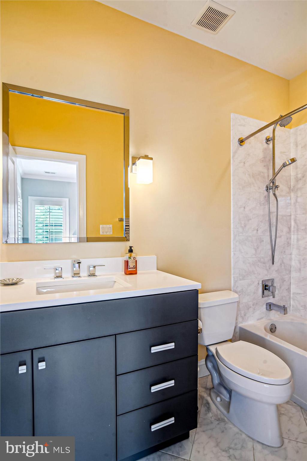 6603 Pyle Road Bethesda, MD 20817 - Photo 56 of 91 a bathroom with a toilet a sink a mirror and shower