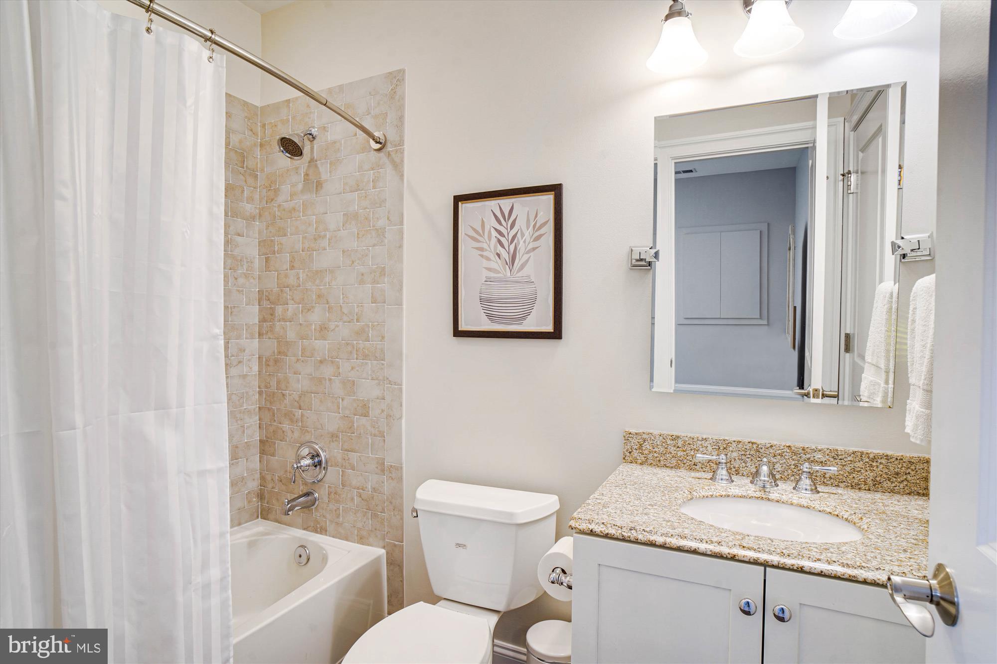 6603 Pyle Road Bethesda, MD 20817 - Photo 81 of 91 a bathroom with a granite countertop sink toilet and shower
