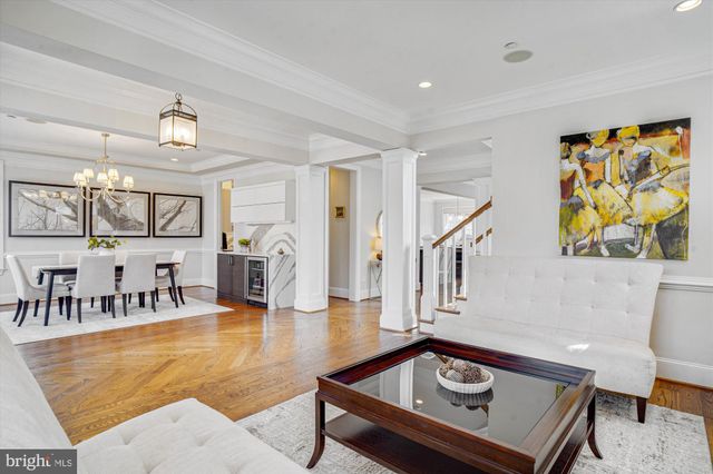 a view of a dining room with furniture a chandelier and wooden floor
