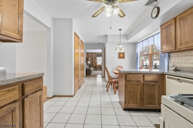 a open kitchen with stainless steel appliances granite countertop a stove and a refrigerator