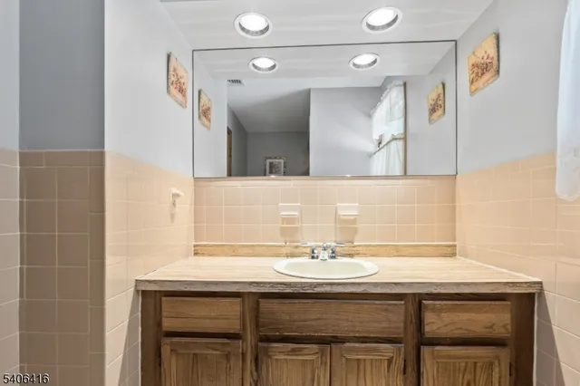 a bathroom with a sink a vanity and a mirror