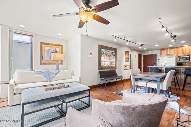 a living room with furniture and a wooden floor