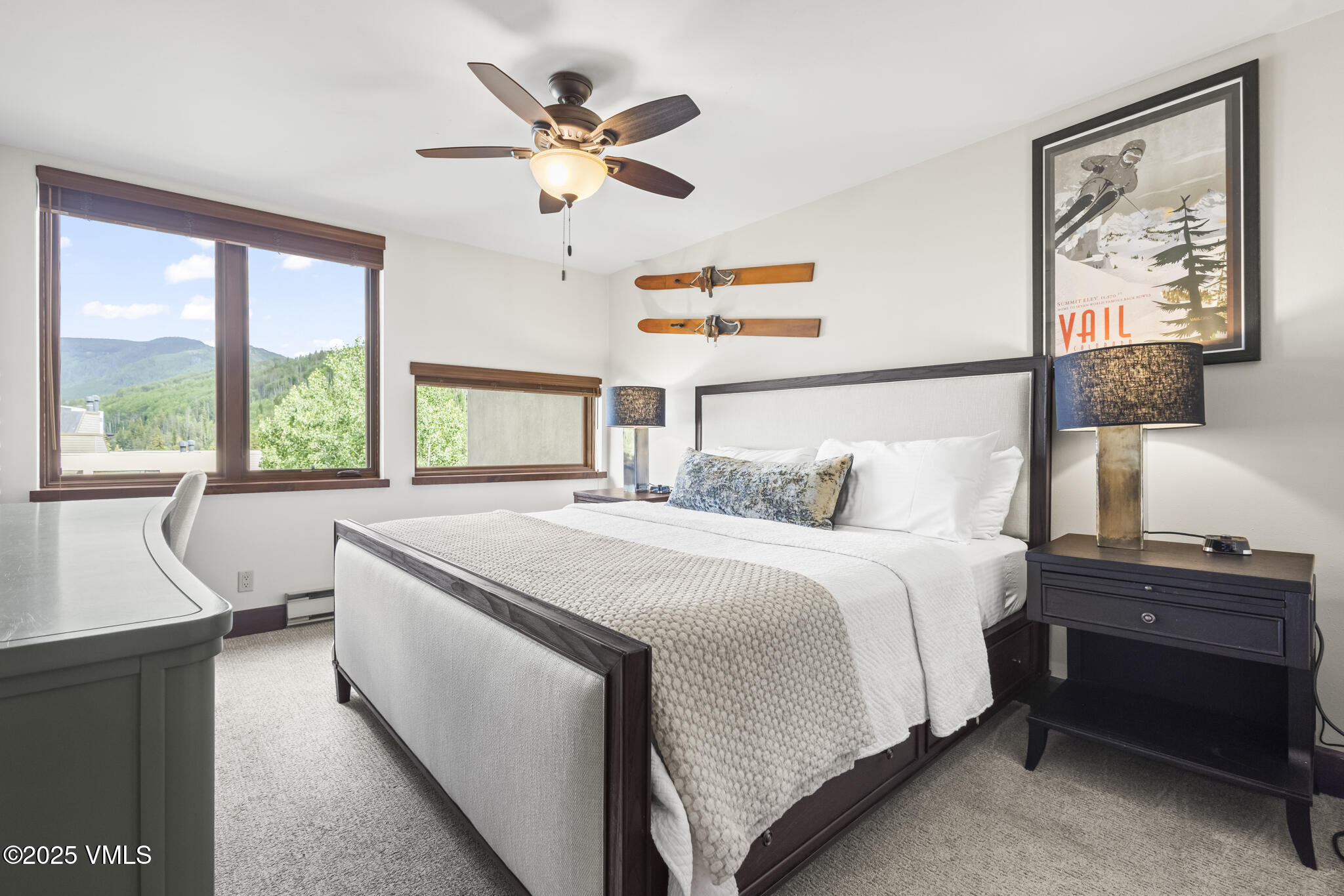 1100 North Frontage Road West, Unit 2504 Vail, CO 81657 - Photo 16 of 35 a bedroom with a large bed and a chandelier