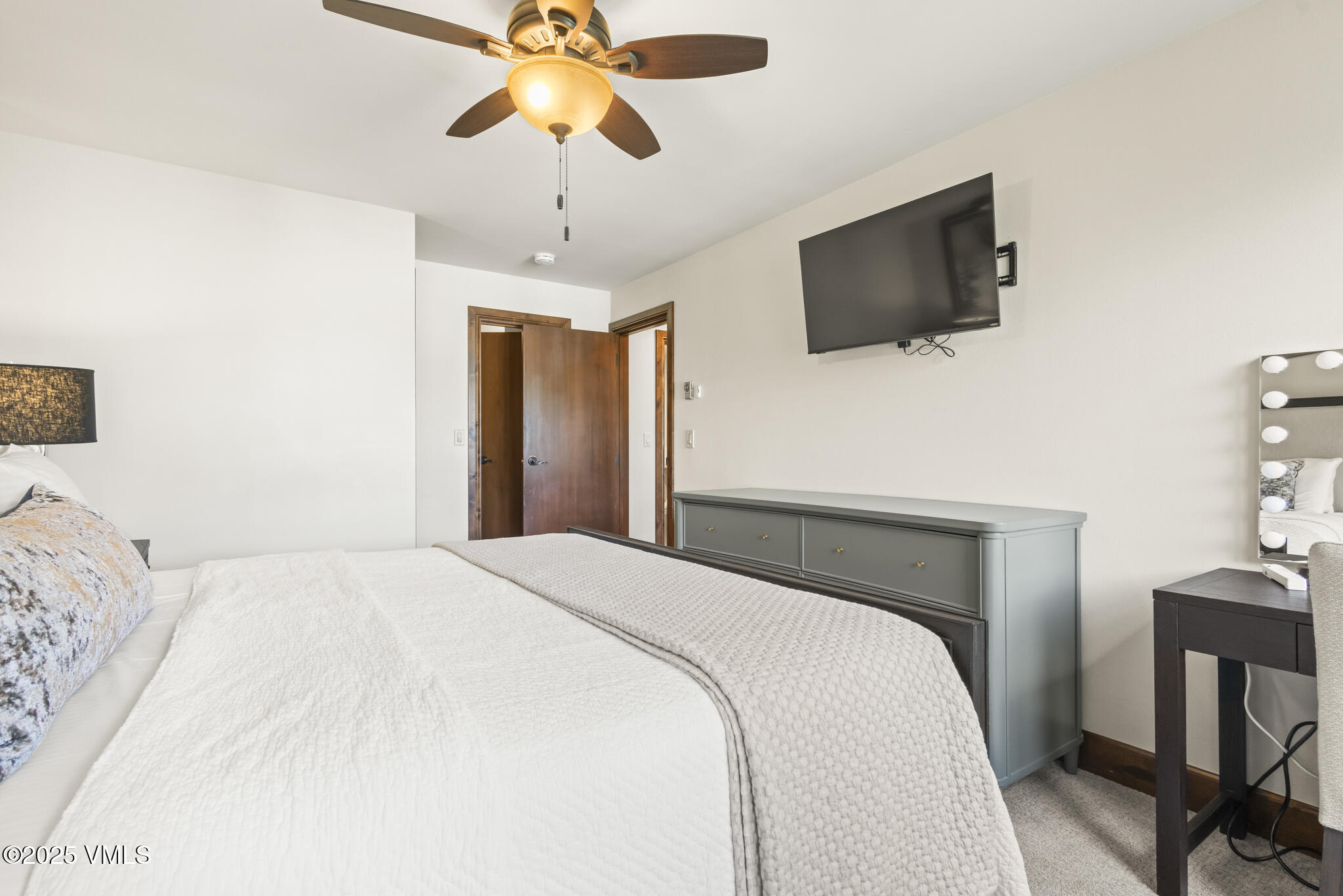 1100 North Frontage Road West, Unit 2504 Vail, CO 81657 - Photo 17 of 35 a bedroom with a bed and a flat screen tv