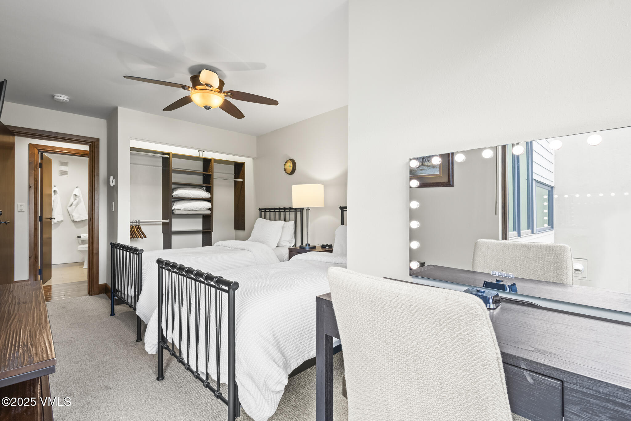 1100 North Frontage Road West, Unit 2504 Vail, CO 81657 - Photo 19 of 35 a bedroom with a bed and a chandelier