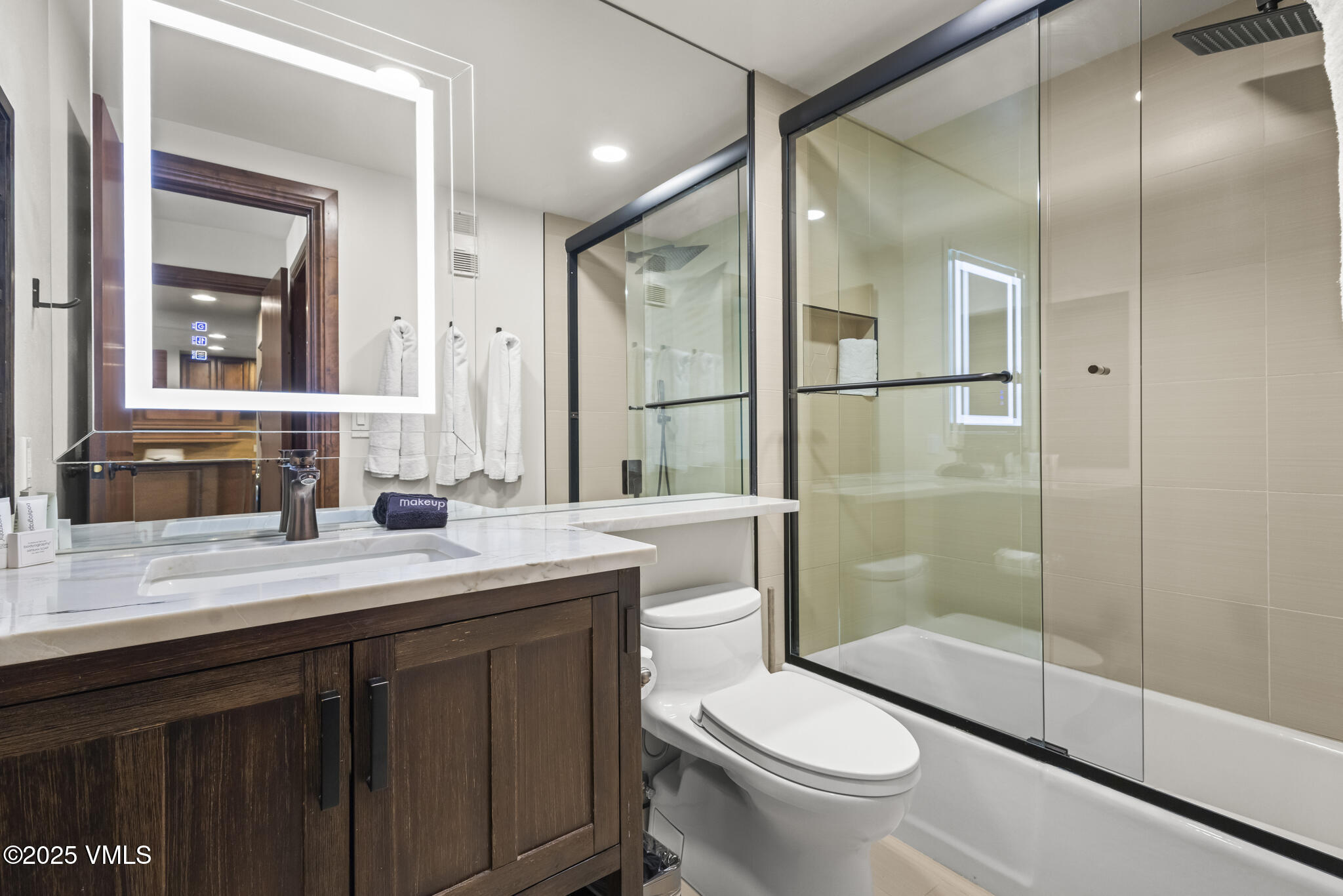 1100 North Frontage Road West, Unit 2504 Vail, CO 81657 - Photo 23 of 35 a bathroom with a shower sink vanity mirror and toilet