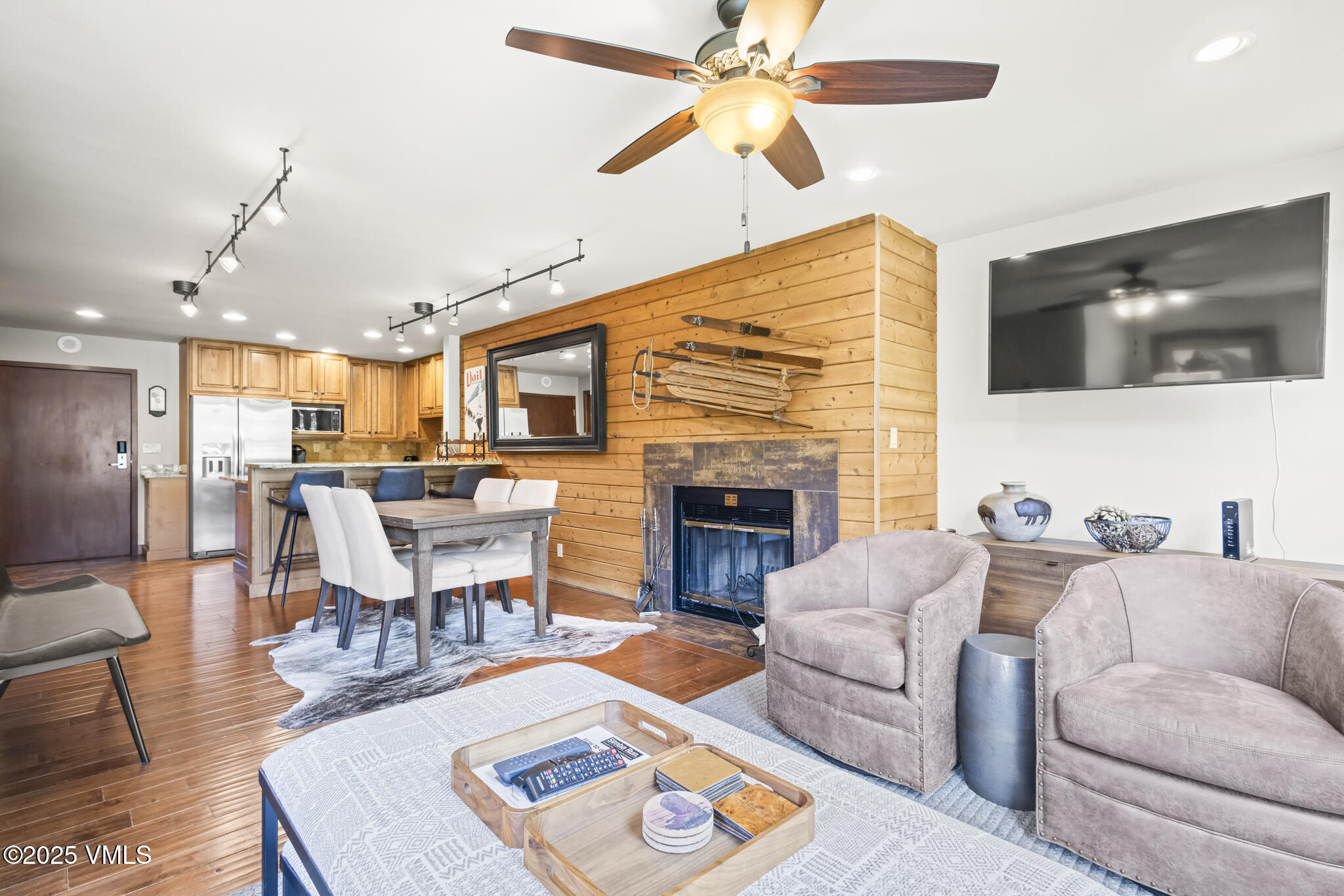 1100 North Frontage Road West, Unit 2504 Vail, CO 81657 - Photo 3 of 35 a living room with furniture a flat screen tv and a fireplace