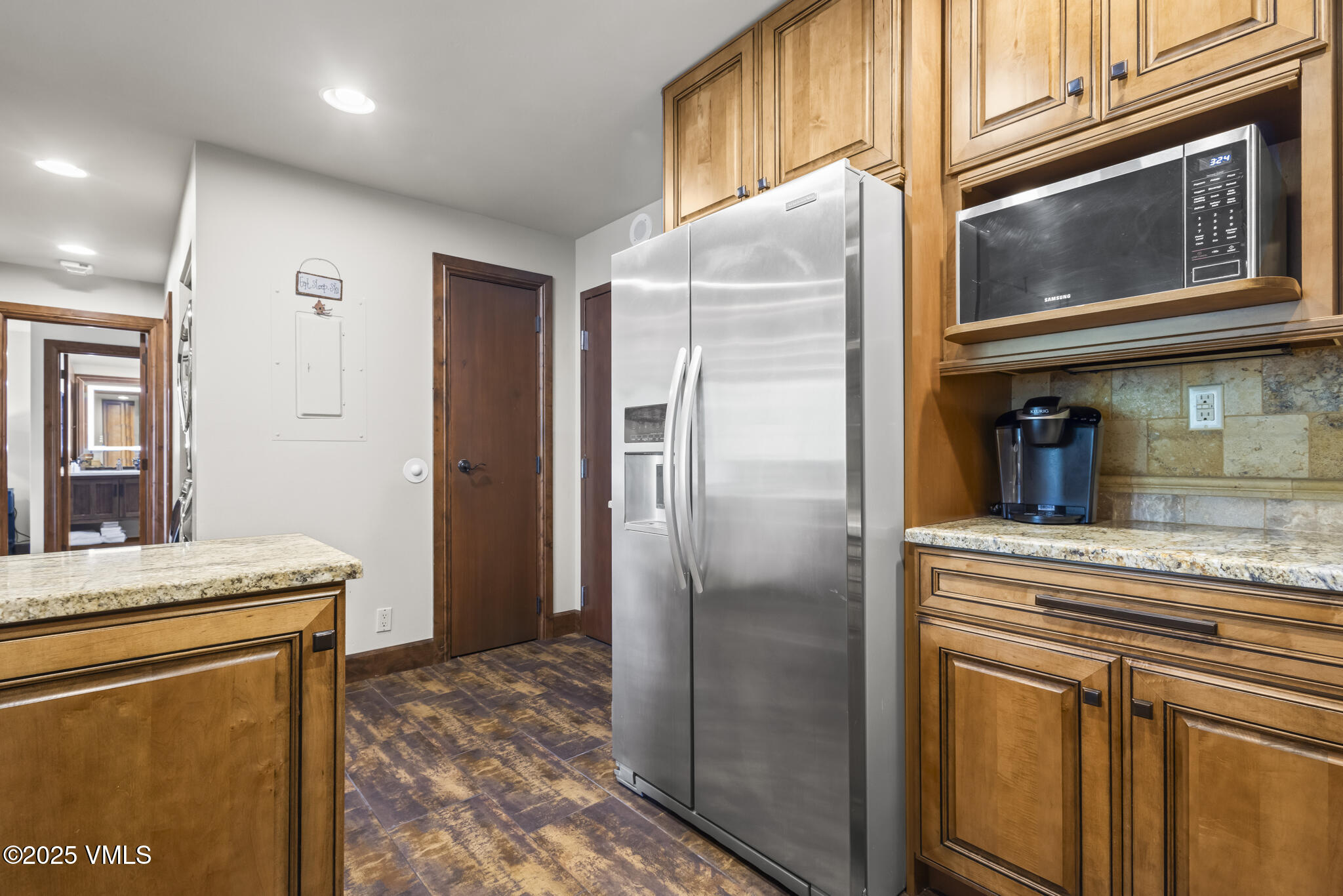 1100 North Frontage Road West, Unit 2504 Vail, CO 81657 - Photo 4 of 35 a kitchen with stainless steel appliances granite countertop a refrigerator and a sink