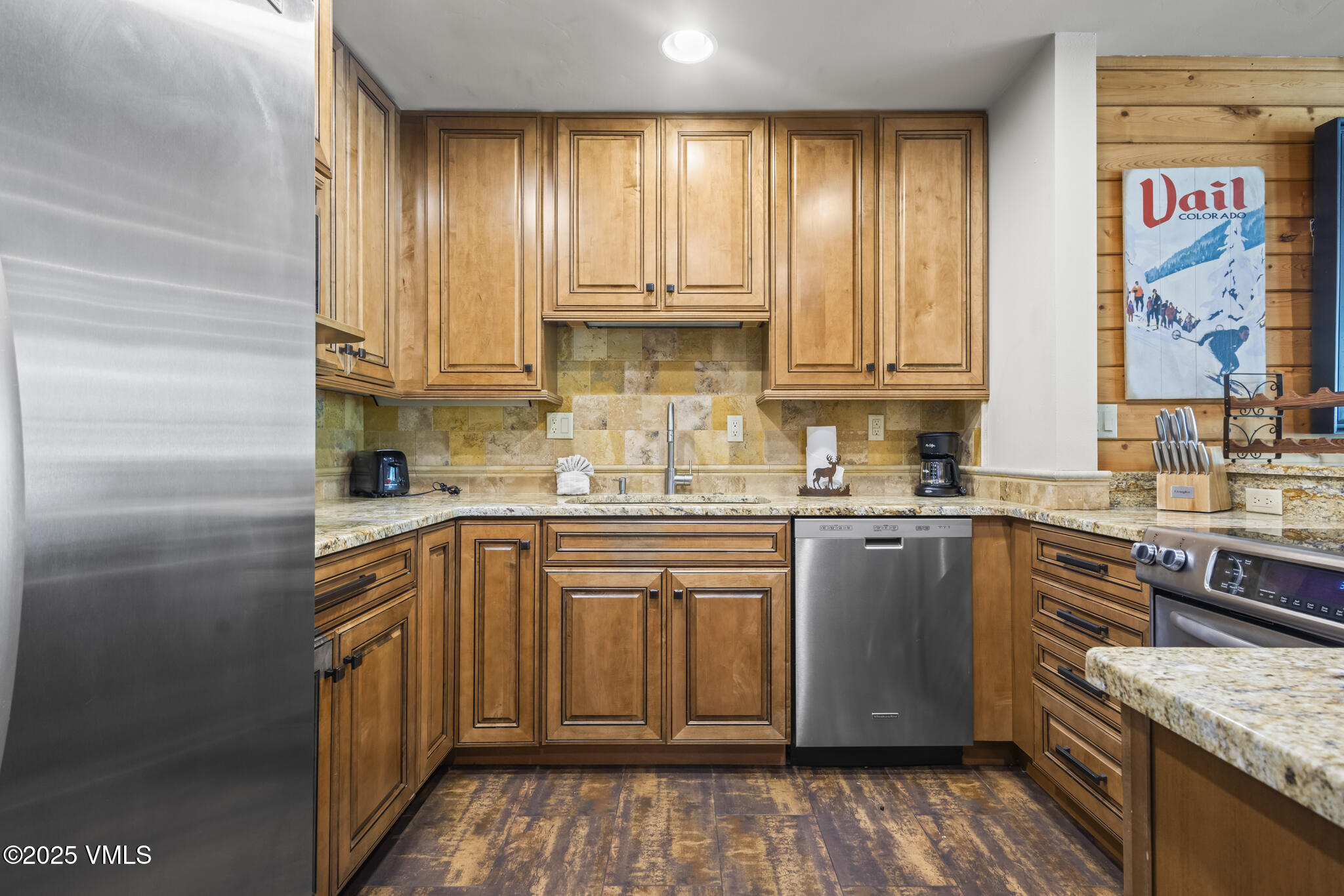 1100 North Frontage Road West, Unit 2504 Vail, CO 81657 - Photo 6 of 35 a kitchen with stainless steel appliances granite countertop a stove a sink and a refrigerator