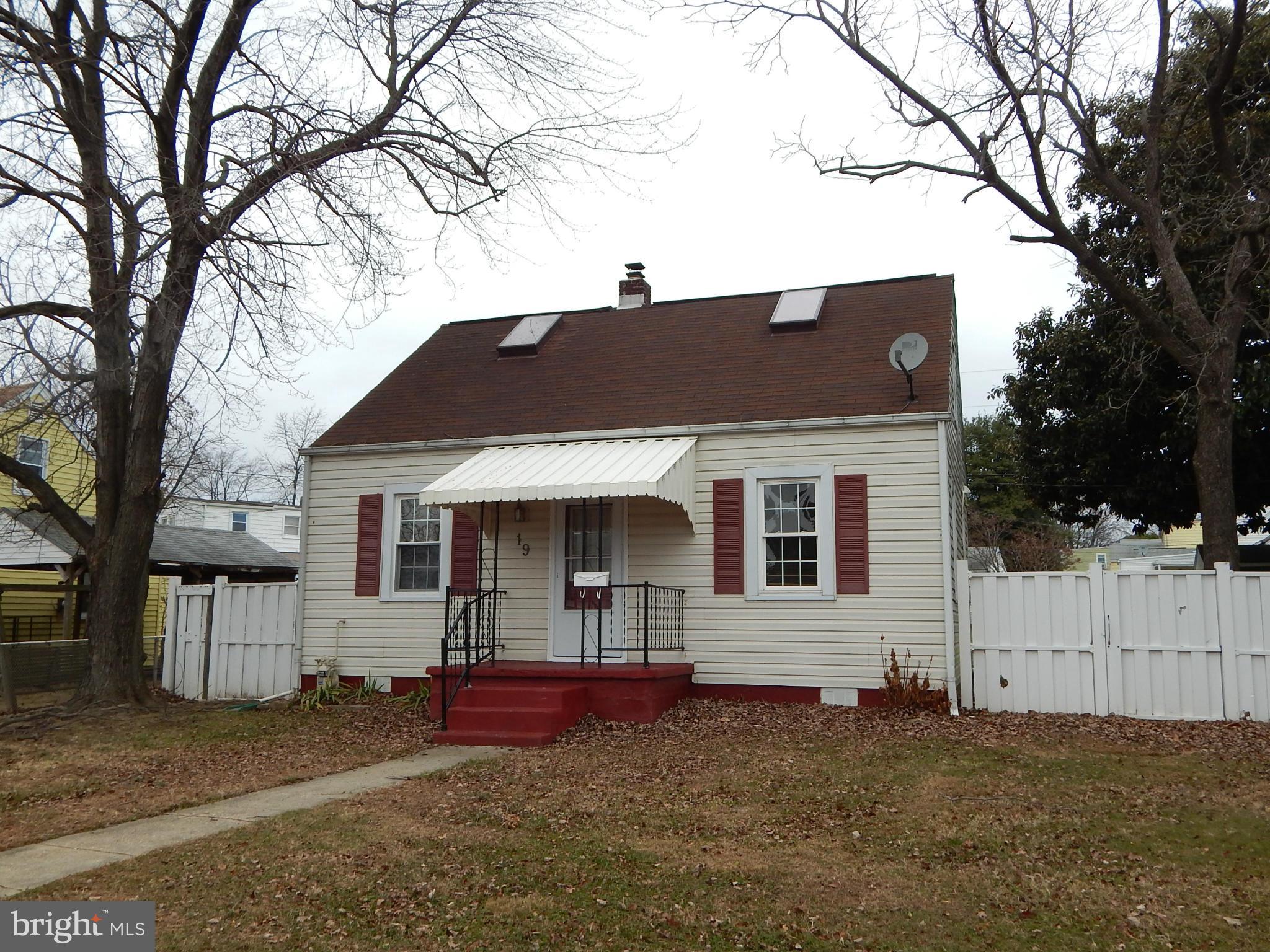 19 Riverside Road Essex, MD 21221 - Photo 2 of 16 a front view of a house with a yard and garage