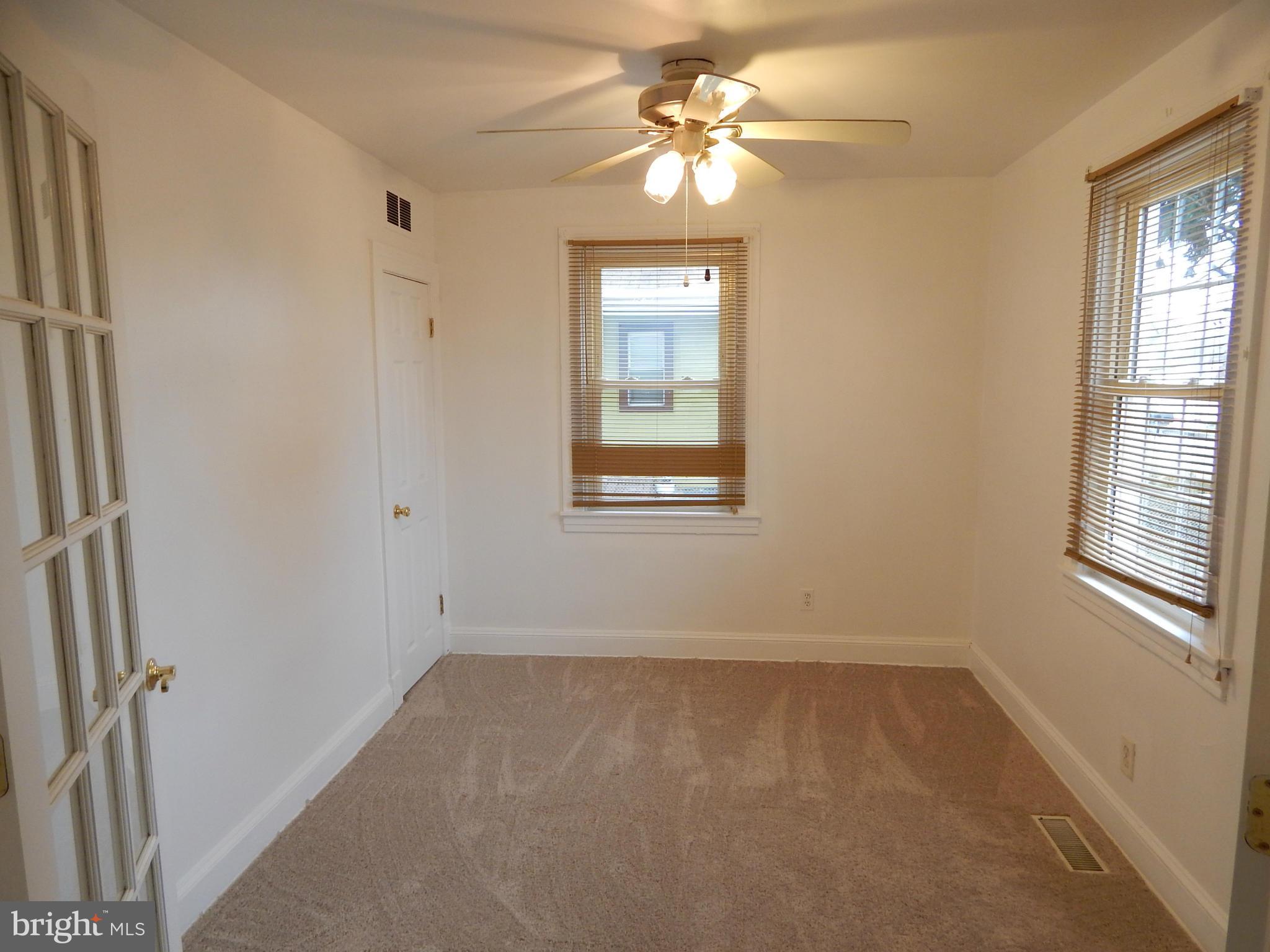 19 Riverside Road Essex, MD 21221 - Photo 6 of 16 an empty room with windows and fan