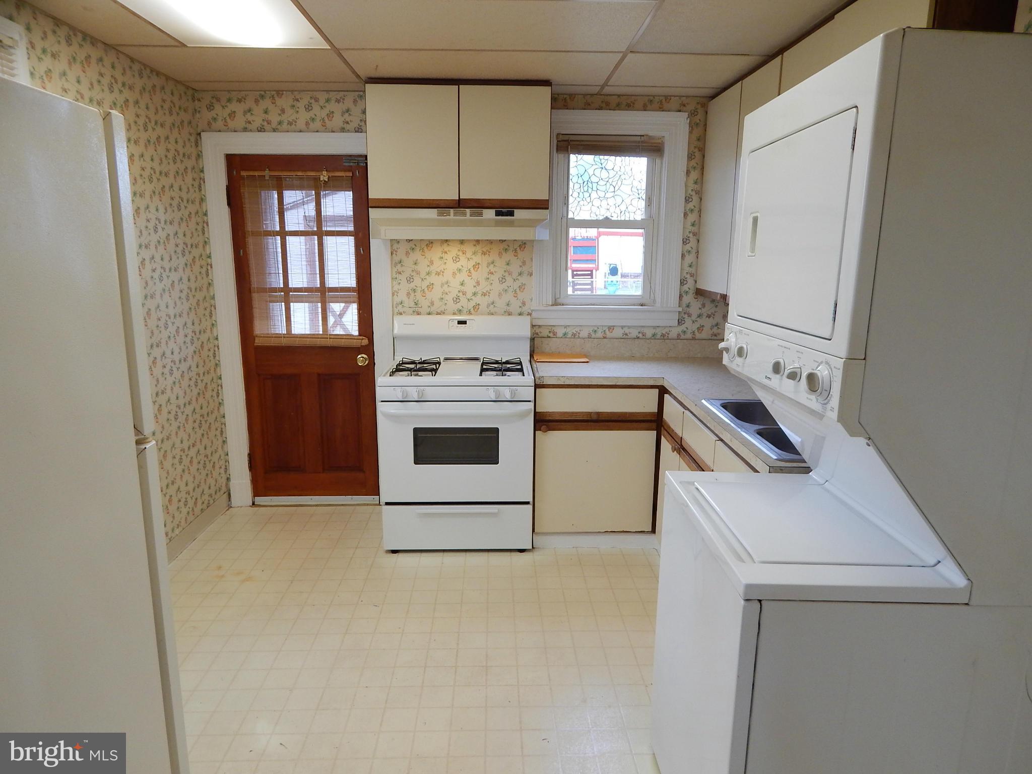19 Riverside Road Essex, MD 21221 - Photo 7 of 16 a kitchen with a stove sink and cabinets