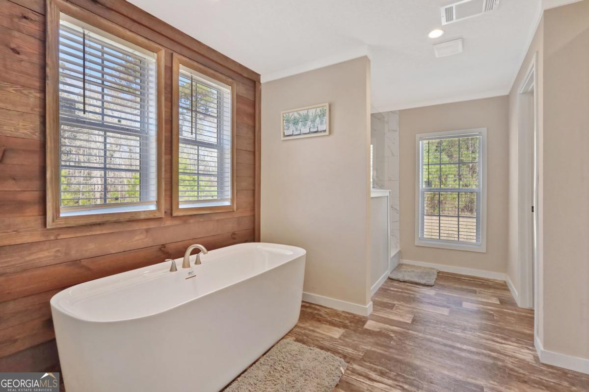 2505 Odum Road South Screven, GA 31560 - Photo 13 of 55 a white bath tub sitting in a bathroom next to a window