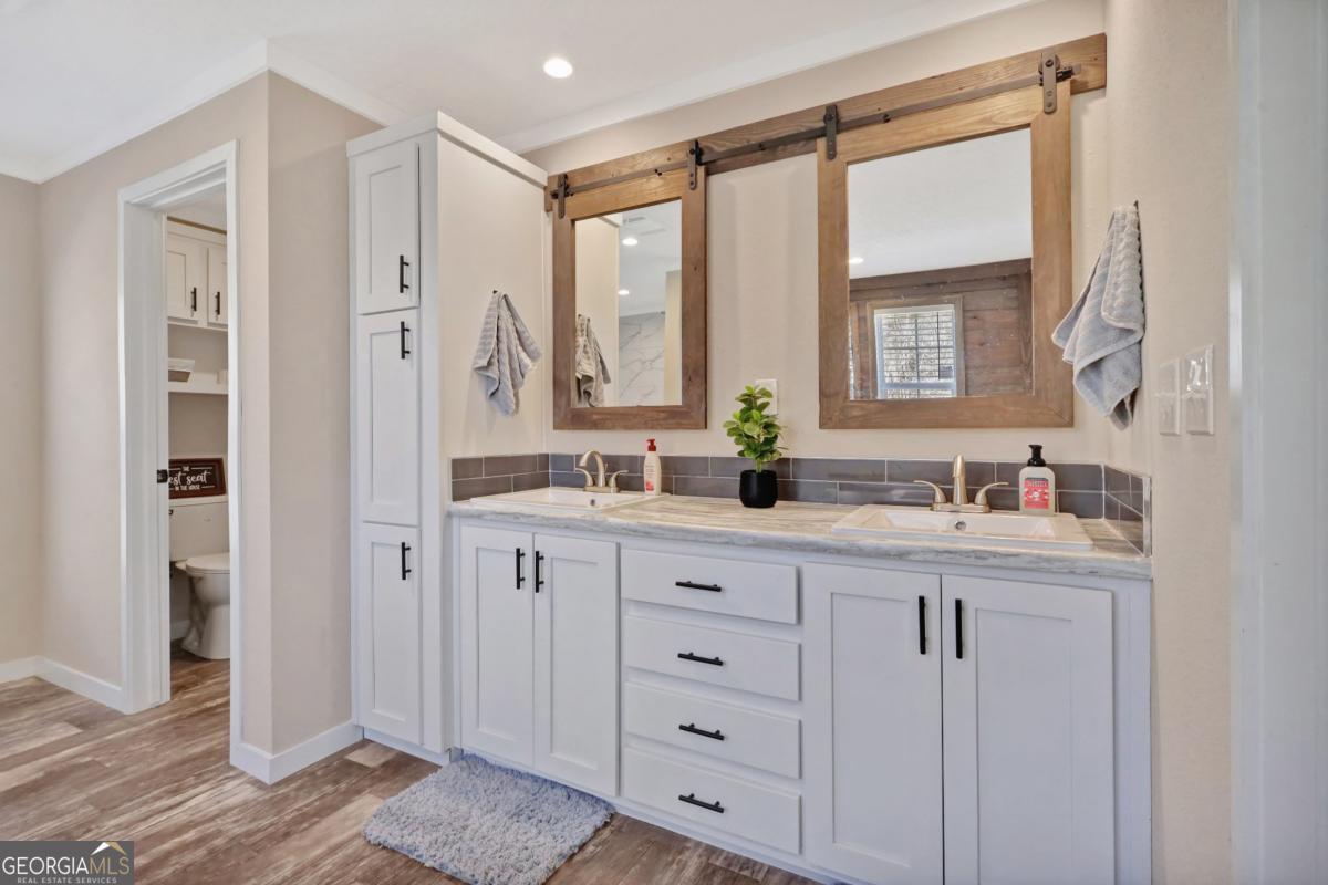 2505 Odum Road South Screven, GA 31560 - Photo 14 of 55 a spacious bathroom with a granite countertop sink mirror and a