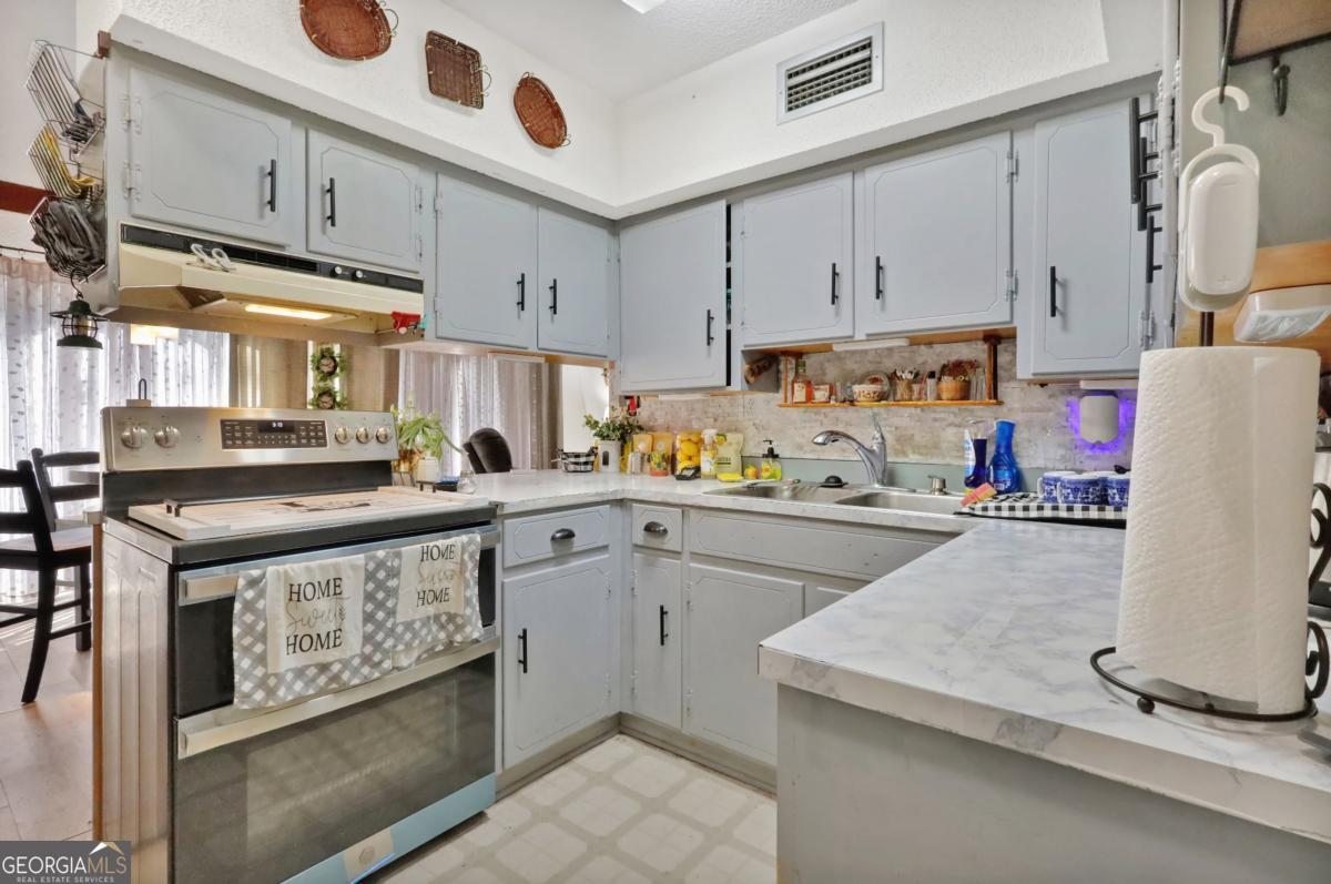 2505 Odum Road South Screven, GA 31560 - Photo 19 of 55 a kitchen with a sink a stove and cabinets