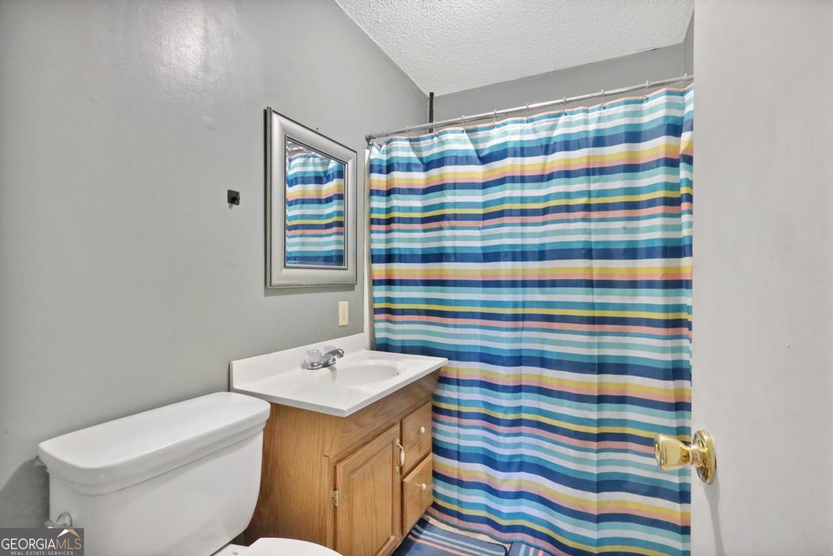 2505 Odum Road South Screven, GA 31560 - Photo 24 of 55 a bathroom with a sink a toilet and shower curtain