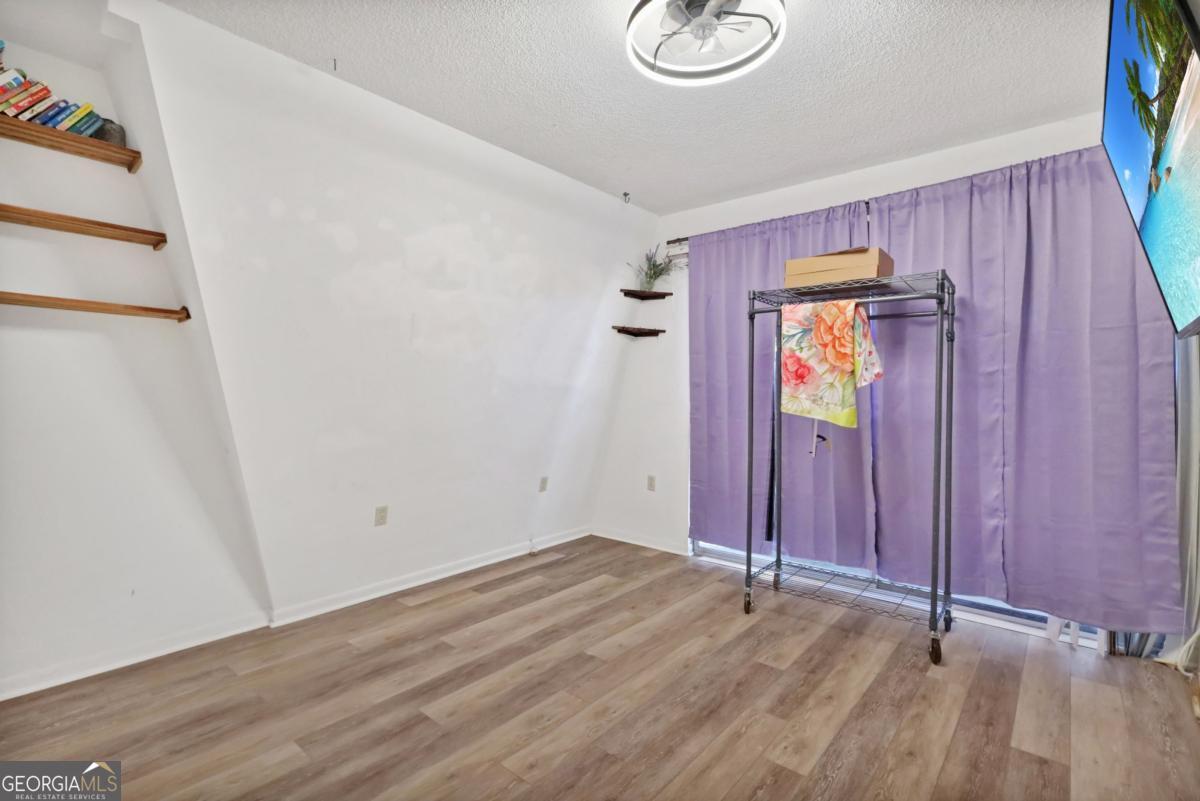 2505 Odum Road South Screven, GA 31560 - Photo 30 of 55 a view of an empty room with wooden floor and a window