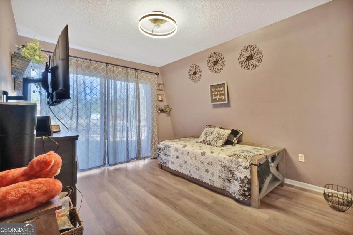 2505 Odum Road South Screven, GA 31560 - Photo 31 of 55 a bedroom with a bed and wooden floor