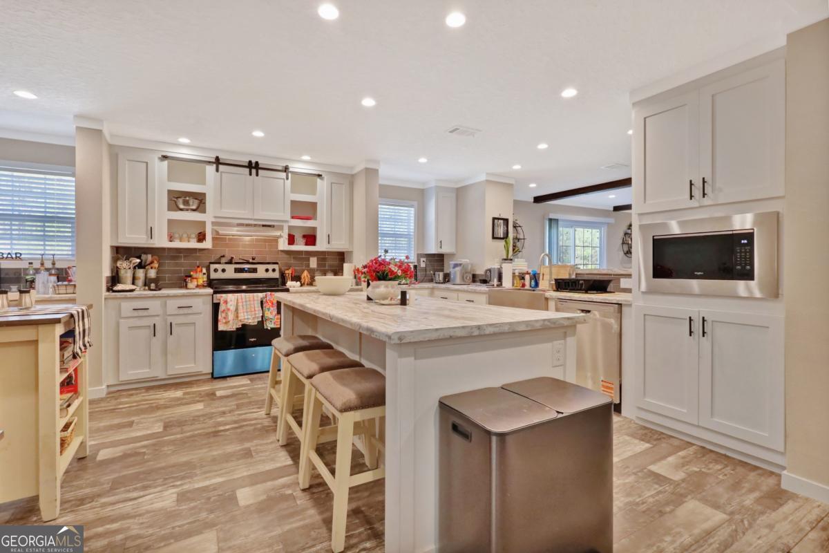 2505 Odum Road South Screven, GA 31560 - Photo 42 of 55 a kitchen with white cabinets and stainless steel appliances