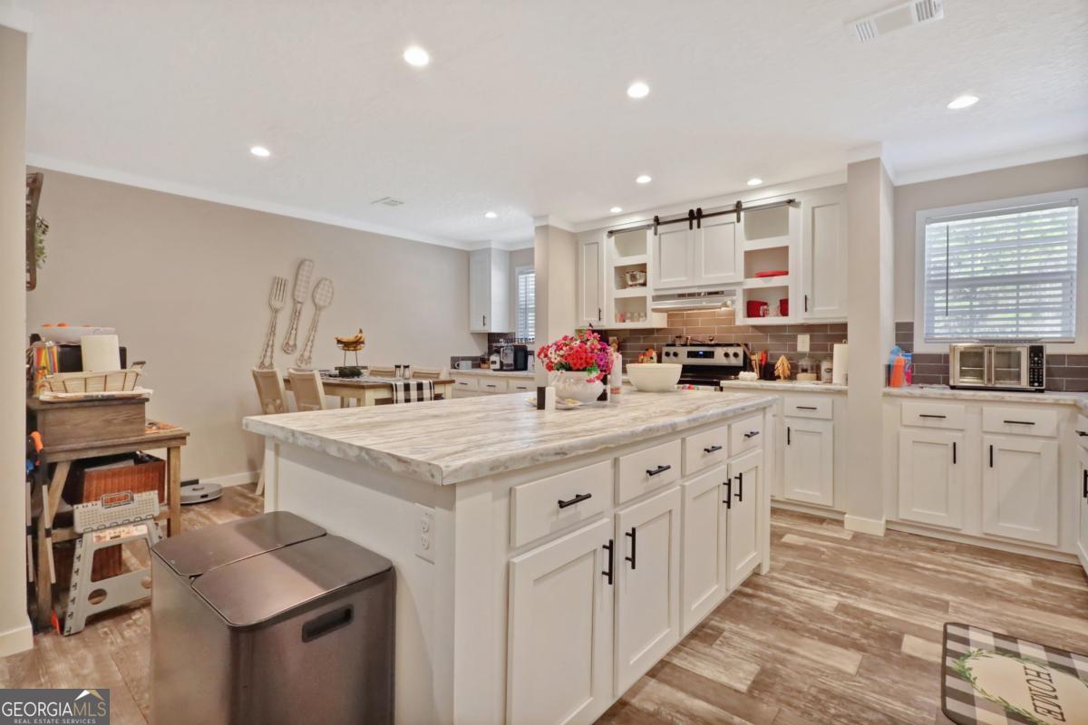 2505 Odum Road South Screven, GA 31560 - Photo 43 of 55 a kitchen with stainless steel appliances kitchen island granite countertop a sink and cabinets