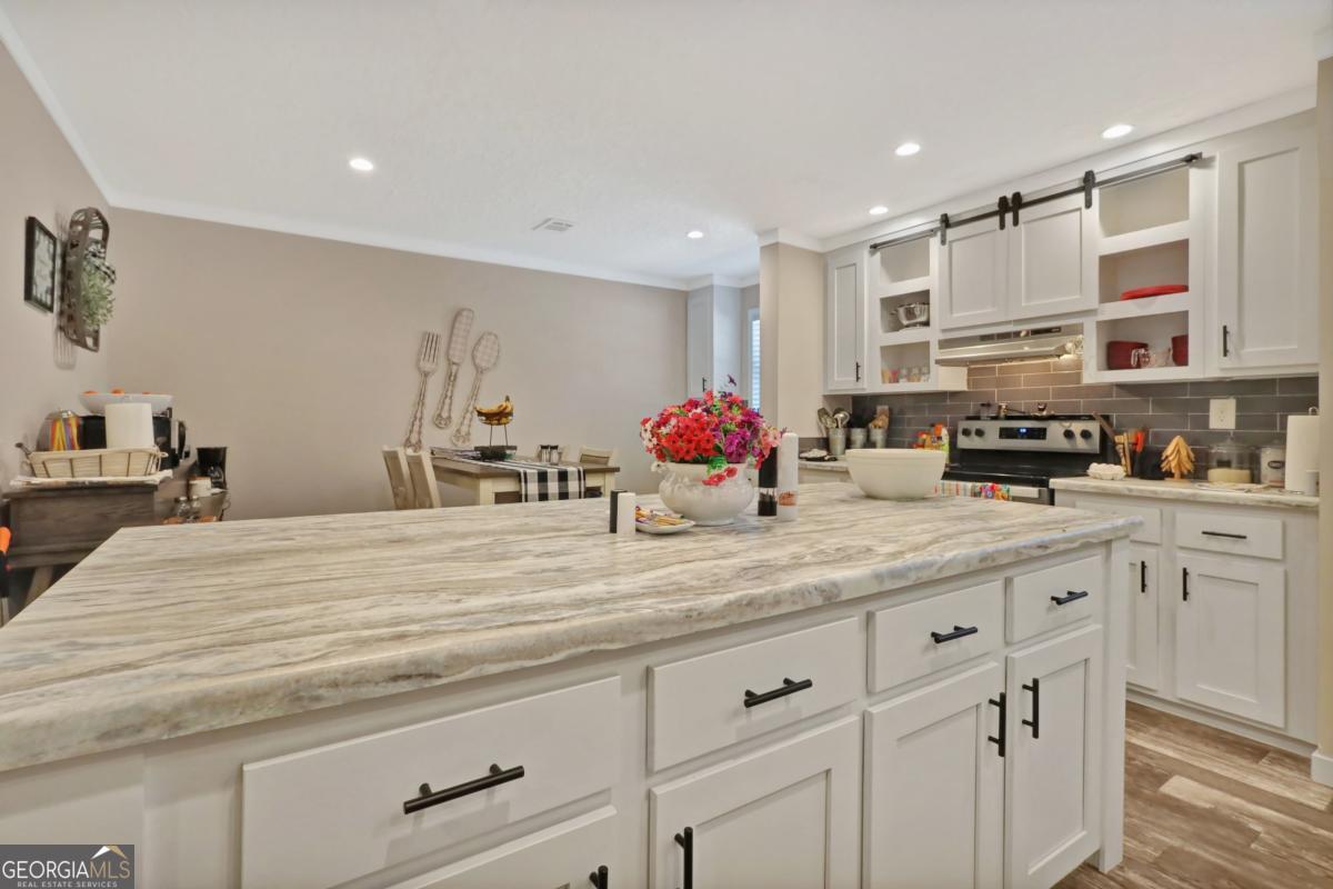 2505 Odum Road South Screven, GA 31560 - Photo 45 of 55 a kitchen with stainless steel appliances kitchen island granite countertop a sink and cabinets