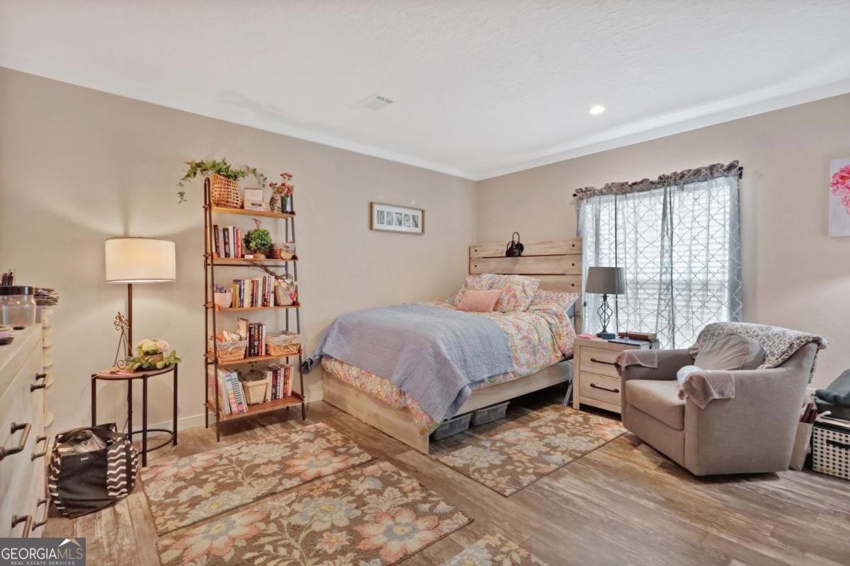 2505 Odum Road South Screven, GA 31560 - Photo 48 of 55 a bedroom with a bed and wooden floor