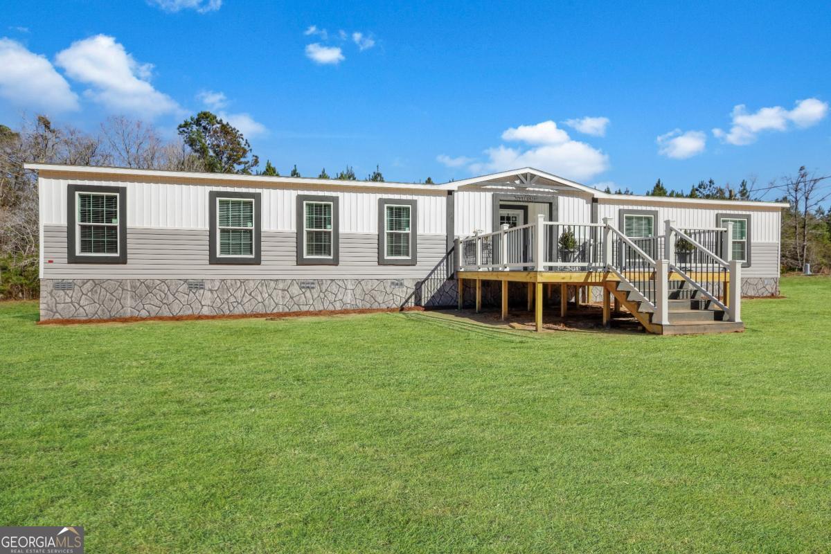 2505 Odum Road South Screven, GA 31560 - Photo 5 of 55 a front view of a house with a garden and yard