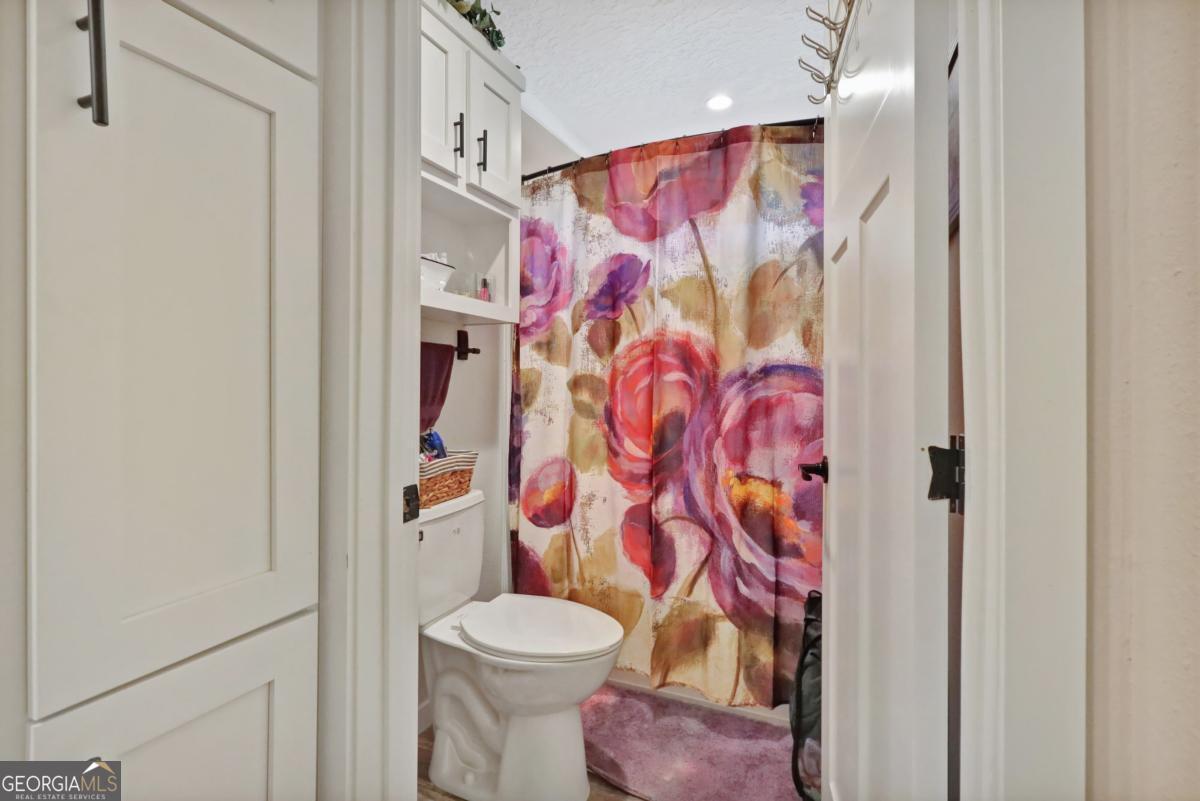 2505 Odum Road South Screven, GA 31560 - Photo 51 of 55 a bathroom with a toilet and shower curtain