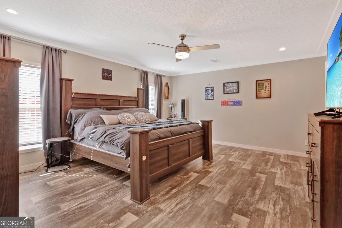 2505 Odum Road South Screven, GA 31560 - Photo 9 of 55 a bedroom with a bed and a chandelier