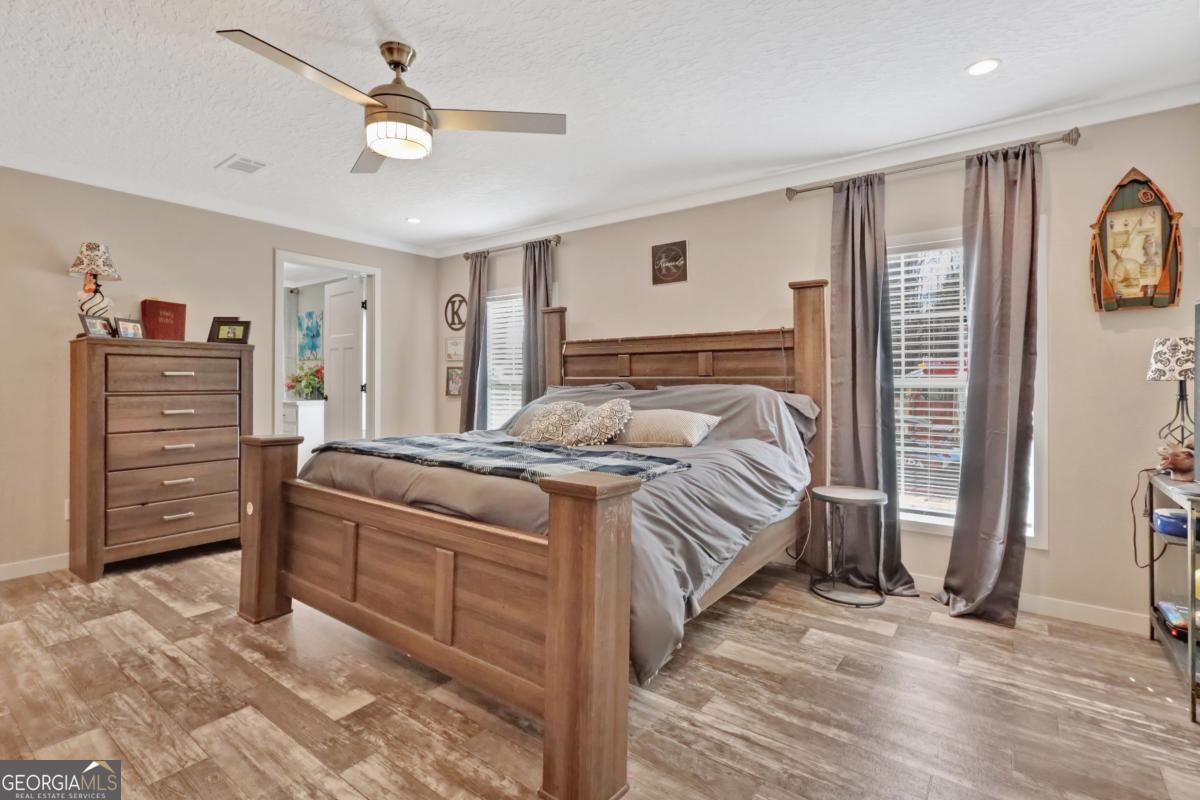 2505 Odum Road South Screven, GA 31560 - Photo 10 of 55 a bedroom with a bed and a chandelier