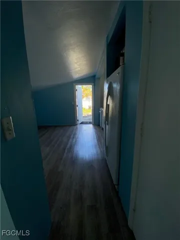 a view of hallway with wooden floor