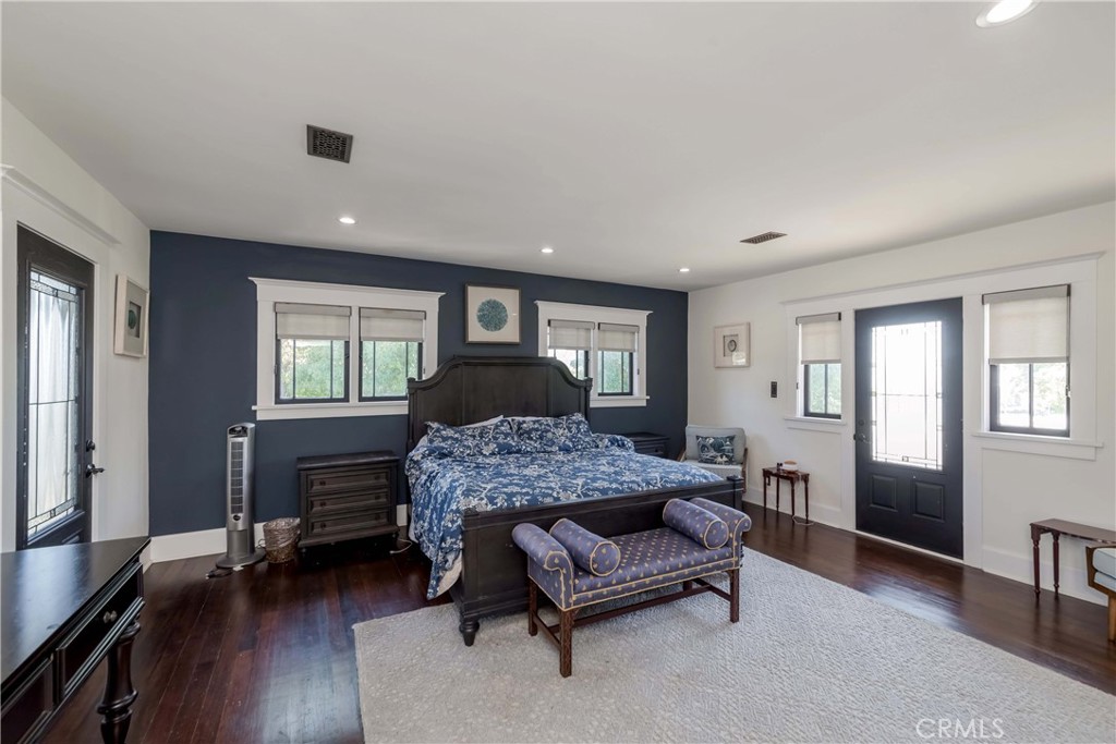 6554 Friends Avenue Whittier, CA 90601 - Photo 3 of 16 a bedroom with a bed wooden floor and furniture