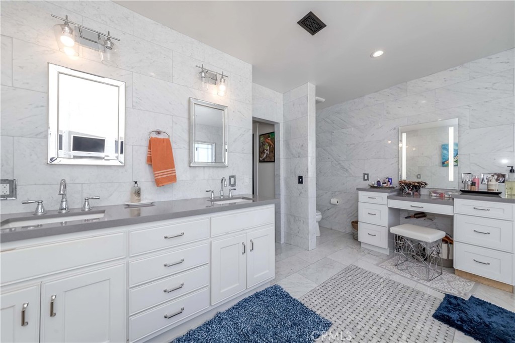 6554 Friends Avenue Whittier, CA 90601 - Photo 5 of 16 a spacious bathroom with a double vanity sink double and mirror