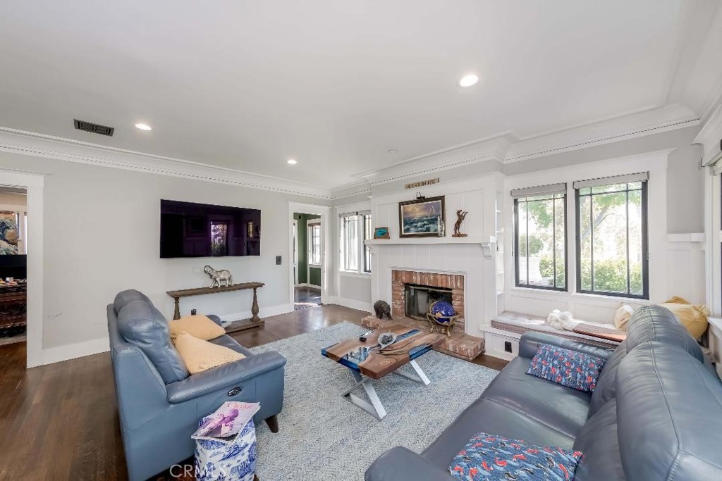 6554 Friends Avenue Whittier, CA 90601 - Photo 8 of 16 a living room with furniture a flat screen tv and a fireplace