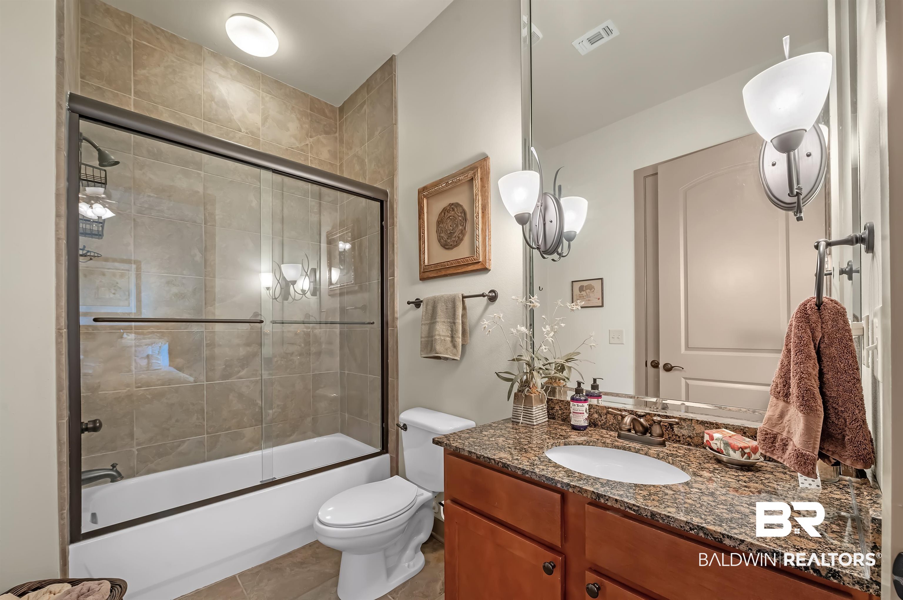 1430 Regency Road, Unit A301 Gulf Shores, AL 36542 - Photo 30 of 47 Full bathroom featuring toilet, combined bath / shower with glass door, vanity, and tile patterned flooring