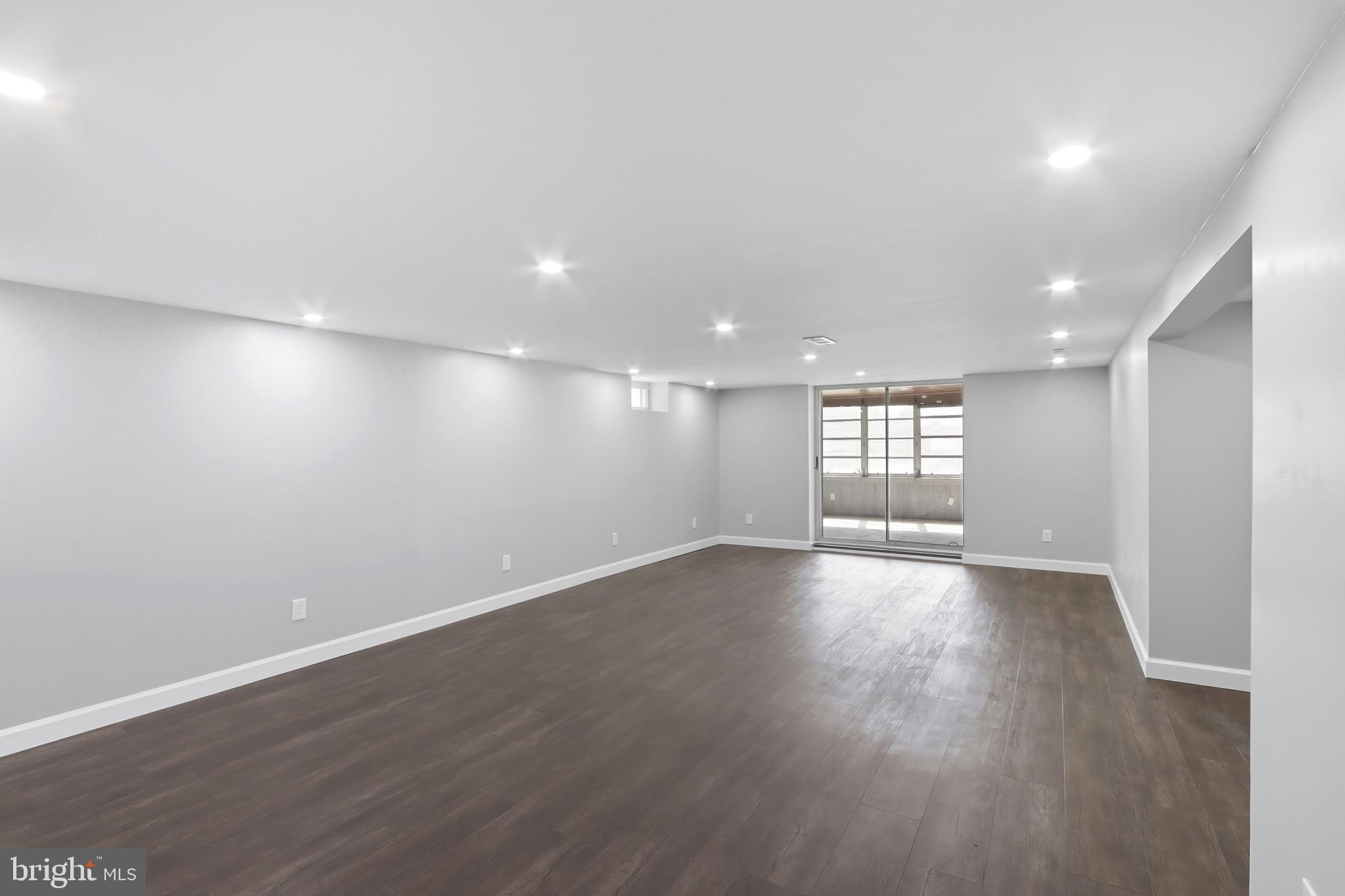 1206 Gettig Road Baltimore, MD 21237 - Photo 19 of 38 an empty room with wooden floor and windows