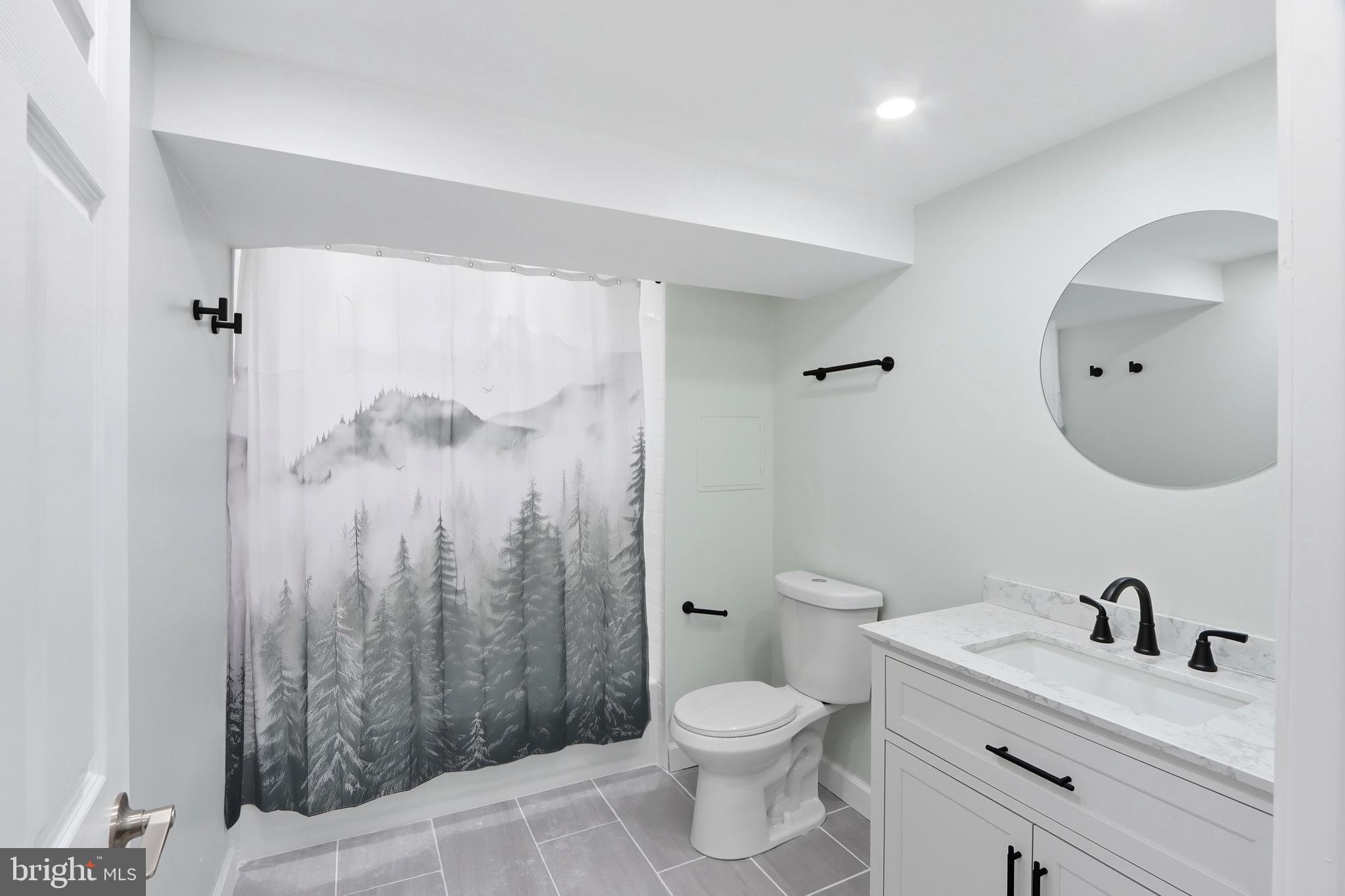 1206 Gettig Road Baltimore, MD 21237 - Photo 24 of 38 a bathroom with a toilet a sink a mirror a shower and vanity